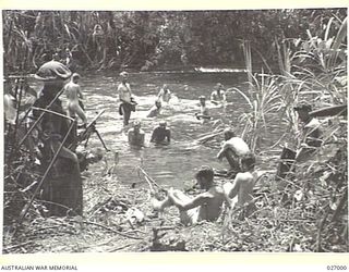 PAPUA, NEW GUINEA. 1942-09. MEN OF THE 2/31ST AUSTRALIAN INFANTRY BATTALION HAVING A BATHE IN THE BROWN RIVER, BETWEEN NAURO AND MENARI. IT WAS THEIR FIRST WASH FOR ABOUT 5 DAYS, DURING THE ADVANCE ..