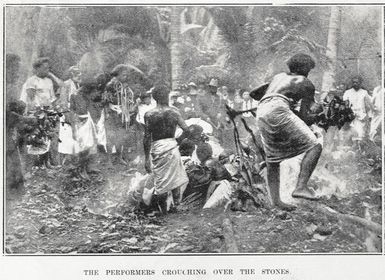 The performers crouching over the hot stones