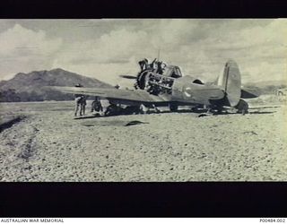 12 MILE STRIP, NEAR PORT MORESBY, NEW GUINEA, C.1942-12. SERVICING PARTY WORKING ON A WIRRAWAY AIRCRAFT