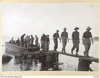 JACQUINOT BAY, NEW BRITAIN, 1945-08-22. MEMBERS OF C COMPANY, 37/52ND INFANTRY BATTALION, COMING ASHORE AT A CATALINA BASE AFTER THEIR RETURN FROM NANTAMBU. THE BATTALION WAS AIRLIFTED BACK TO ..