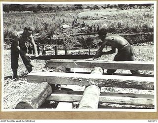 BEBEI, NEW GUINEA. 1943-12-21. NX91313 SAPPER SHEPHERD (LEFT) AND VX79422 LANCE CORPORAL R. J. BAKER OF THE 2/6TH AUSTRALIAN FIELD COMPANY, BUILDING TRESTLES FOR A BRIDGE OVER THE FARIA RIVER