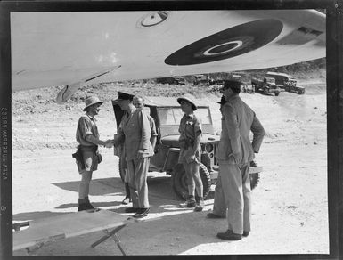 Royal New Zealand Air Force camp, New Hebrides (Vanuatu), showing group of unidentified RNZAF personnel under the wing of a Consolidated PBY Catalina flying boat