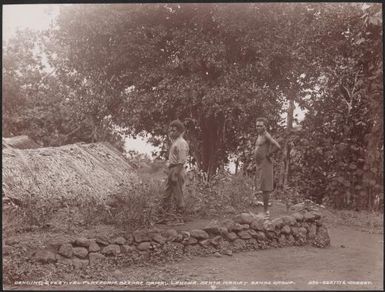 Two men beside a dancing and festival platform at Lakona, Santa Maria, Banks Islands, 1906 / J.W. Beattie