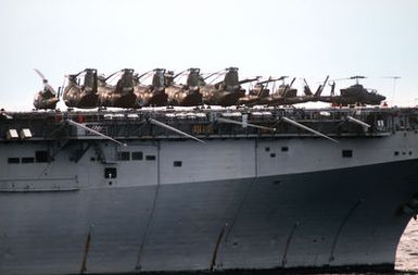 UH-1N Iroquois, CH-46 Sea Knight, and AH-1T Sea Cobra helicopters are parked on the bow of the amphibious assault ship USS SAIPAN (LHA 2) during NATO Exercise NORTHERN WEDDING '86