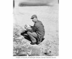 CAPT. Christian L. Engleman holding a crab on Uku Island, summer 1947