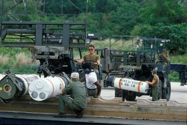 US Air Force personnel use forklifts to unload Mark 52 air-delivered underwater mines from a pallet during Exercise TEAM SPIRIT'86