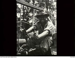 NADZAB, NEW GUINEA. C. 1944-02. LEADING AIRCRAFTMAN R. HENDRY OF HELENSBURGH, NSW, AND NOW OF NO. 62 MOBILE WORKS SQUADRON RAAF, OFTEN WISHES HE HAD MORE THAN TWO HANDS AS HE HAS TO MANIPULATE ..