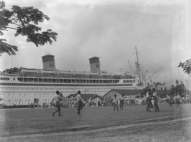 [Children on football field in front of ship "Mariposa", Tahiti?]