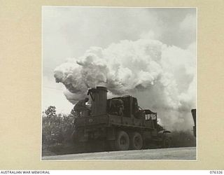 LAE, NEW GUINEA. 1944-09-27. PERSONNEL OF A UNITED STATES ARMY CHEMICAL WARFARE UNIT TESTING A PORTABLE SMOKE SCREEN TRUCK IN CO OPERATION WITH THE 43RD FIELD ORDNANCE DEPOT