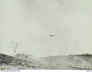 PORT MORESBY, PAPUA, 1943-11-11. A DOUGLAS TRANSPORT AIRCRAFT FLYING OVER THE FOUR MILE VALLEY AFTER TAKING OFF FROM JACKSON FIELD AT THE SEVEN MILE VALLEY