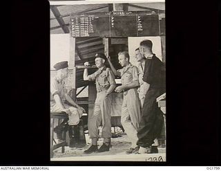 MOMOTE, LOS NEGROS ISLAND, ADMIRALTY ISLANDS. C. 1944-04. SQUADRON LEADER IAN LOUDON, THE COMMANDING OFFICER OF NO. 76 (KITTYHAWK) SQUADRON RAAF, LEFT, WITH A FEW OF HIS PILOTS. LEFT TO RIGHT: ..