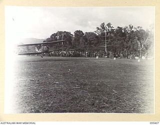 KIARIVU EMERGENCY LANDING GROUND, 1945-08-13. AIRCRAFT FLOWN BY FLYING OFFICER W.H.R. SMITH, COMES IN LOW FOR A CLOSE INSPECTION OF THE AIRSTRIP WHICH IS IN 2/7 INFANTRY BATTALION AREA. IT HAS BEEN ..