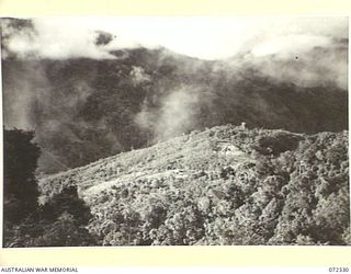 MISSION HILL, NEW GUINEA. 1944-04-06. FROM THE ROCK FACE CUT OVER MISSION HILL (FOREGROUND), SHOWING THE DIFFICULTIES OF TERRAIN ENCOUNTERED BY THE 23RD LINE SECTION, 18TH LINES OF COMMUNICATION ..