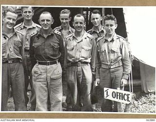 RAMU VALLEY, NEW GUINEA. 1944-01-15. PERSONNEL OF THE INTELLIGENCE SECTION OF THE 57/60TH INFANTRY BATTALION OUTSIDE THE SECTION OFFICE. THEY ARE: VX111339 CORPORAL R. J. THORPE (1); VX142241 ..