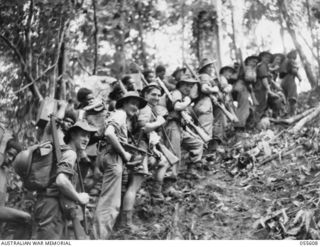 GOODVIEW, NEW GUINEA. 1943-08-11. TROOPS OF "C" COMPANY, 2/7TH AUSTRALIAN INFANTRY BATTALION PREPARING TO MOVE TO FRONT LINE POSITIONS. LEFT TO RIGHT:- WX15687 PRIVATE (PTE) W. GODDARD; NX126533 ..