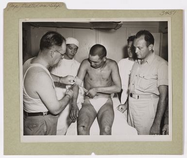 Photograph of a Japanese Prisoner of War Being Examined and Treated by American Medical Officers