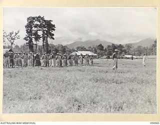 LAE AREA, NEW GUINEA. 1945-08-13. COLONEL I.J. WOOD, COMMANDING OFFICER, 2/7 GENERAL HOSPITAL, ADDRESSING A PARADE OF STAFF AT THE HOSPITAL