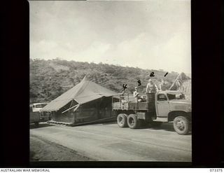 Port Moresby, New Guinea. 1944-05-23. A truck from the 117th Station Hospital, United States Army, towing one of the hospital's wards along the Rouna Road to a new site. Traffic on the road is ..