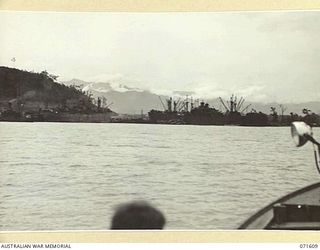 LAE, NEW GUINEA. 1944-03-24. LAE, VIEWED FROM THE HARBOUR SHOWING LIBERTY SHIPS UNLOADING AT THE WHARVES