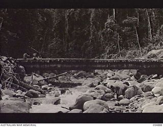 BULLDOG-WAU ROAD, NEW GUINEA, 1943-07-12. BRIDGE BUILT OVER A MOUNTAIN CREEK AT 15 MILE POINT BY TROOPS OF THE ROYAL AUSTRALIAN ENGINEERS, 11TH AUSTRALIAN DIVISION