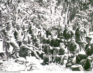 THE SOLOMON ISLANDS, 1945-05. A GROUP OF AUSTRALIAN ARMY PERSONNEL AT A CAMP AT NORTH BOUGAINVILLE. (RNZAF OFFICIAL PHOTOGRAPH.)