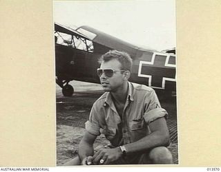 PORT MORESBY, PAPUA. 12 NOV 1942. STAFF SERGEANT N.D. MAXWELL OF CLAIRE, MICHIGAN, PILOT OF AN AMBULANCE PLANE WHICH HAS BROUGHT MANY A WOUNDED AUSTRALIAN BACK FROM THE KOKODA FRONT