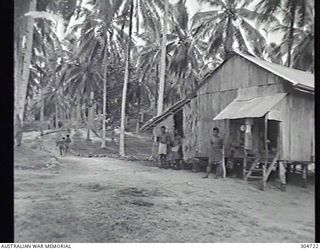 SEGI AREA, NEW GEORGIA, BRITISH SOLOMON ISLANDS PROTECTORATE. C.1944. NATIVE SCOUTS FOR THE NAVAL INTELLIGENCE DIVISION, RAN, (RESPONSIBLE FOR THE COASTWATCHERS), STANDING IN FRONT OF THEIR ..