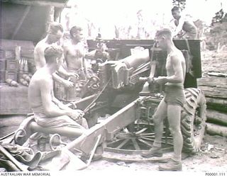 THE SOLOMON ISLANDS, 1945-04-24/27. AN AUSTRALIAN ARTILLERY CREW SERVICING THEIR 25 POUND GUN ON BOUGAINVILLE ISLAND. (RNZAF OFFICIAL PHOTOGRAPH.)