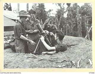 CRATER HILL, FINISTERRE RANGE, NEW GUINEA, 1944-02-16. MEMBERS OF A MORTAR DETACHMENT OF "B" COMPANY, 58/59TH INFANTRY BATTALION SETTING THEIR MORTAR AT CRATER HILL. IDENTIFIED PERSONNEL ARE: ..