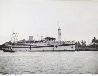 MADANG, NEW GUINEA. 1944-08-15. THE 2/1ST AUSTRALIAN HOSPITAL SHIP, "MANUNDA" TIED UP AT THE TOWN WHARF WHILE WAITING TO LOAD CASUALTIES