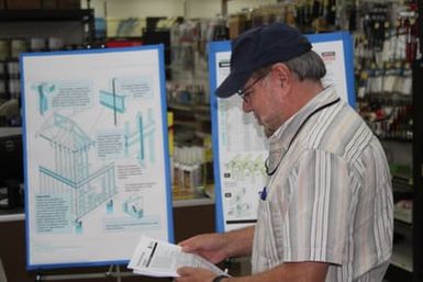 Mario Verde, Hazard Mitigation Specialist, distributes hazard mitigation rebuilding fact sheets to the public at True Value Hardware. After Typhoon Soudelor hit the island in August, many residents are in the process of rebuilding damaged homes.