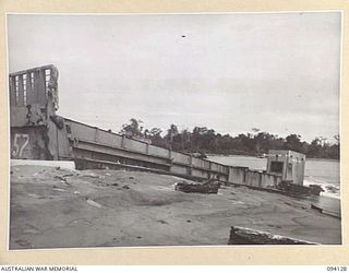BUNA, NEW GUINEA, 1945-07-03 TO 1945-07-04. "LUCY LEE LO", A WRECKED ALLIED LANDING CRAFT, ON BUNA BEACH