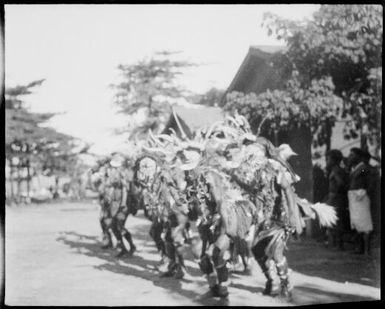 Side view of a double row of decorated dancers, New Guinea, ca. 1929 / Sarah Chinnery