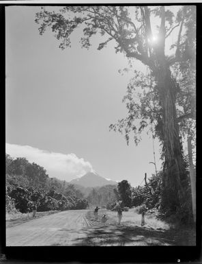 View from a forest road with locals looking at the erupting volcano of Mount Bagana, Bougainville Island, North Solomon Island group