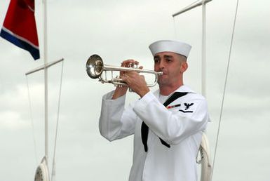 A U.S. Navy Sailor, U.S. Pacific Fleet Band, sounds"Taps"during a joint Navy/National Park Service ceremony commemorating the 65th Anniversary of the attack on Pearl Harbor on Dec. 7, 2006, at Pearl Harbor, Hawaii. More than 1,500 Pearl Harbor survivors, their families and their friends from around the nation joined the more than 2,000 distiguished guests and the general public for the annual observance. (U.S. Navy photo by Mass Communication SPECIALIST 1ST Class James E. Foehl) (Released)