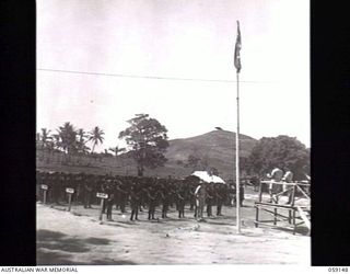 KILA, NEW GUINEA. 1943-10-24. NATIVES OF THE NATIVE LABOUR CAMP ON THE PARADE GROUND LISTENING TO AN ADDRESS BY PP1 MAJOR GENERAL B. M. MORRIS DSO, GENERAL OFFICER COMMANDING, AUSTRALIAN AND NEW ..