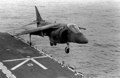 An AV-8B Harrier aircraft attached to Marine Medium Helicopter Squadron 261 (HMM-261) comes in for a landing on the flight deck of the amphibious assault ship USS SAIPAN (LHA 2) during a rehearsal for Operation Sharp Edge. The SAIPAN is on station off the coast of Liberia