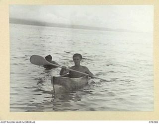 SWAN BEACH, NEW BRITAIN. 1945-01-07. LANCE CORPORAL J.F. BURKETT, 16TH INFANTRY BATTALION, THE WINNER OF THE CANOE RACE (CANOE HAD TO BE MADE FROM A TREE TRUNK) AT THE SWIMMING AND BOATING CARNIVAL ..