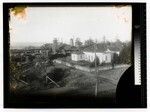 [House in foreground, lumber mill in background]