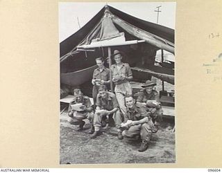 CAPE WOM, WEWAK AREA, NEW GUINEA. 1945-09-15. TROOPS OF HEADQUARTERS 6 DIVISION READING MAIL FROM HOME. IDENTIFIED PERSONNEL ARE:- PRIVATE F.R. HUTCHINSON (1); PRIVATE R.A. GRAVES (2); PRIVATE A.B. ..