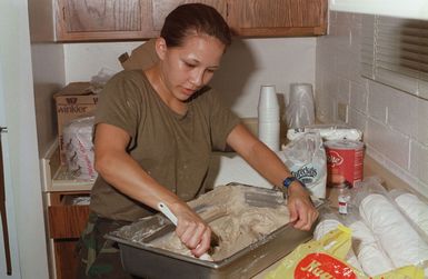 CPL. Amanda Tianco, Combat Service Support Detachment 37, mixes icing that will go on deserts served during chow at a Marine Joint Task Force operation