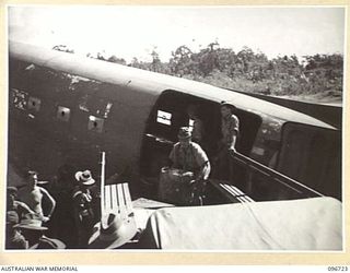 WEWAK AIRSTRIP, NEW GUINEA, 1945-09-20. JAPANESE PERSONNEL UNLOADING GEAR FROM A DOUGLAS C47 DAKOTA AIRCRAFT, AFTER ARRIVAL FROM HAYFIELD AT HQ 6 DIVISION. THEY WERE MET BY STAFF OFFICERS FROM 6 ..