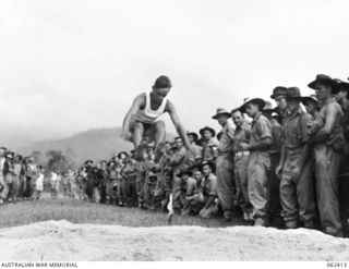 17 MILE, PORT MORESBY AREA, PAPUA, NEW GUINEA. 1943-12-25. VX141515 PRIVATE E. V. LEE (1) OF NO. 1 SUB DEPOT COMPETING IN THE BROAD JUMP EVENT AT THE 10TH AUSTRALIAN ADVANCED ORDNANCE DEPOT SPORTS ..