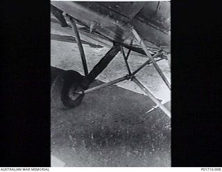 PORT MORESBY, NEW GUINEA. 1943-01-16. REPAIRED UNDERCARRIAGE OF A TIGER MOTH AIRCRAFT FLOWN BY TOM FRENCH, NO. 1 AIR SEA RESCUE SQUADRON, RAAF. HE AND LIEUTENANT SNOOKS OF AUSTRALIAN NEW GUINEA ..
