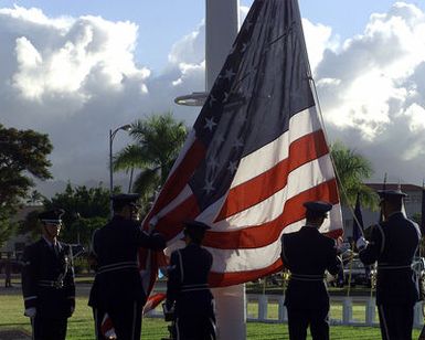 Hickam Air Force Base Honor Guard members raise the colors for the opening of the December 7th, 1941 Pearl Harbor memorial ceremony