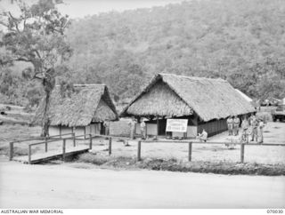 PORT MORESBY, NEW GUINEA. 1944-01-22. THE RECREATION HUT AND BARBERS SHOP BUILT BY THE 2/101ST GENERAL TRANSPORT COMPANY IN THEIR CAMP AREA. BOTH WERE FURNISHED AND GAMES WERE SUPPLIED BY THE ..