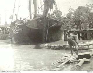 TERAPO, NEW GUINEA, 1943-09-16. KETCH AK94 TYING UP AT THE AUSTRALIAN MOVEMENT CONTROL WHARF. TRAWLER AS22 CAN BE SEEN PULLING ALONGSIDE