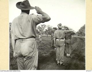 GUSIKA, NEW GUINEA. 1944-04-09. MEMBERS OF THE 2/4TH LIGHT ANTI-AIRCRAFT REGIMENT AT A MEMORIAL SERVICE HELD IN HONOUR OF MEMBERS WHO WERE KILLED IN ACTION IN THE FINSCHHAFEN - SCARLET BEACH AREA. ..