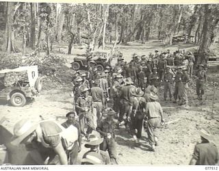 BOUGAINVILLE ISLAND. 1944-12-06. TROOPS OF THE 15TH INFANTRY BATTALION ENJOYING A CUP OF TEA AT THE ROADSIDE STALL OF THE YOUNG MEN'S CHRISTIAN ASSOCIATION DURING THEIR MOVE INTO THE FORWARD AREA ..