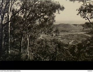 Port Moresby, New Guinea. 1944-05-08. An elevated view looking towards the sea from Pyramid Hill, showing the now deserted Kila Aerodrome in the centre